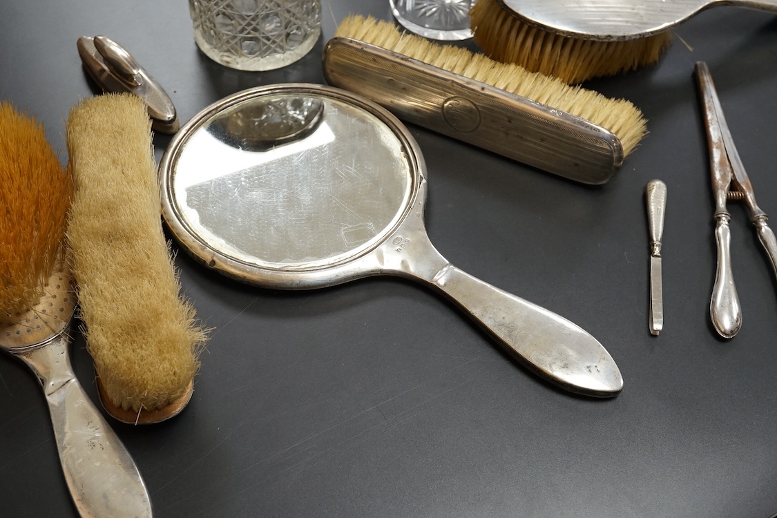 Ten assorted silver mounted dressing table items, including brushes, hand mirror, manicure items and glove stretchers.